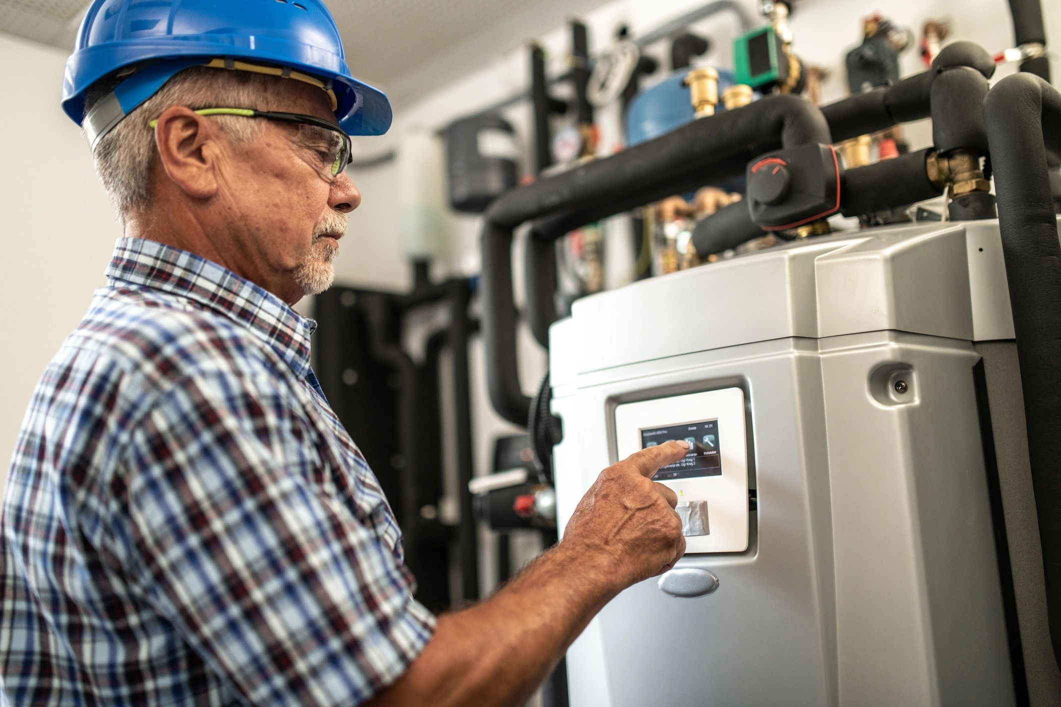 Heating technician checking a control panel