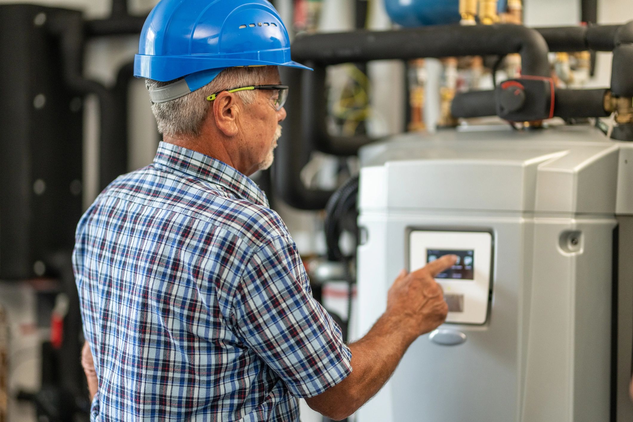 Technician inspecting a home heating control panel