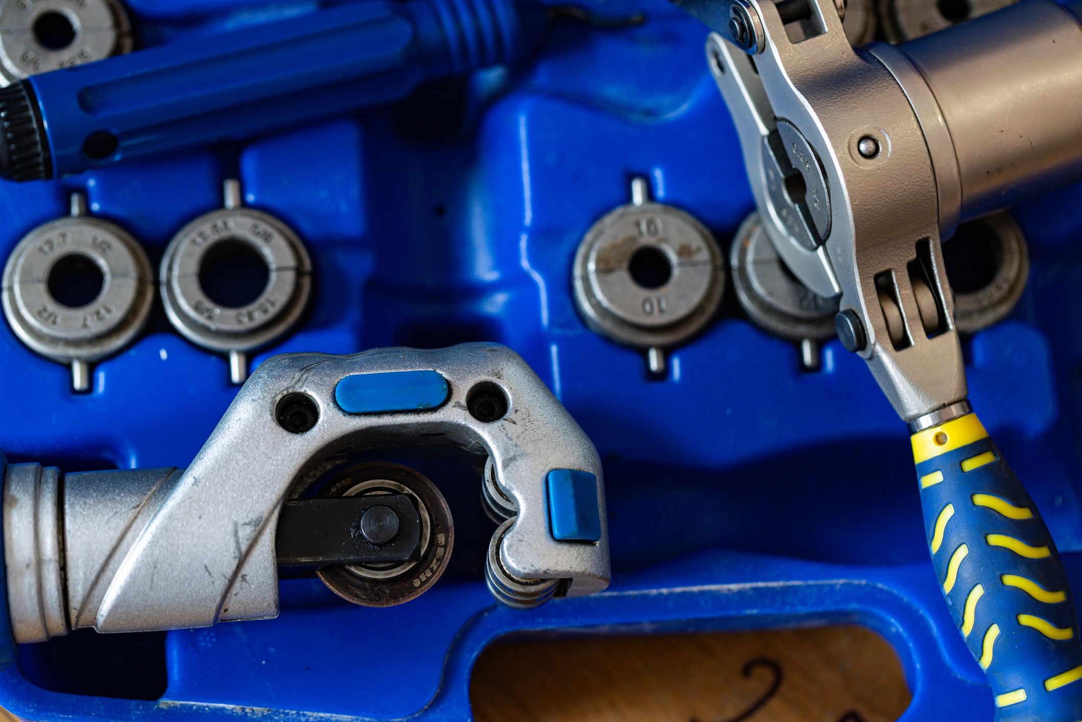 Pipe cutter and press tools in a blue case