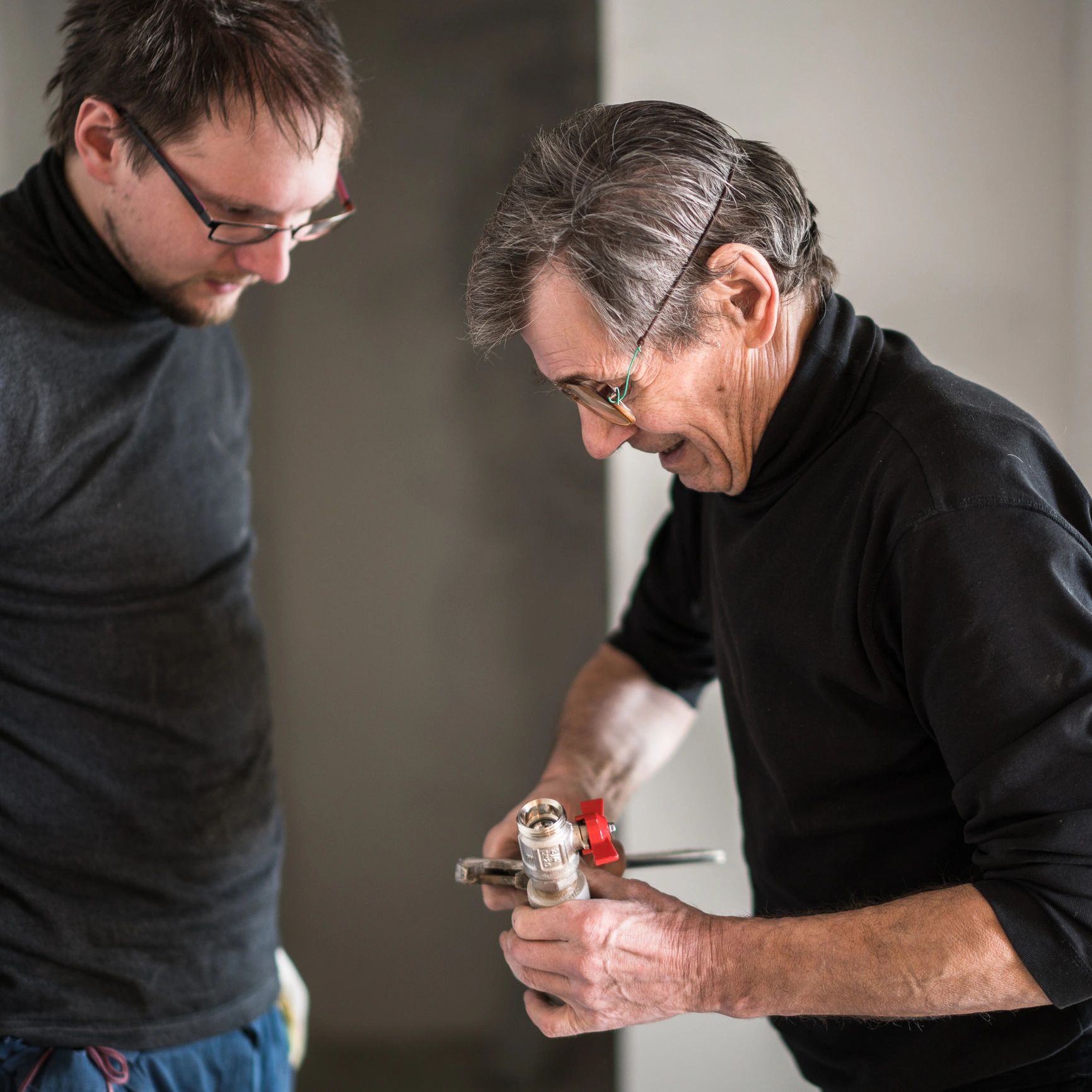 Two plumbers working together on a home renovation